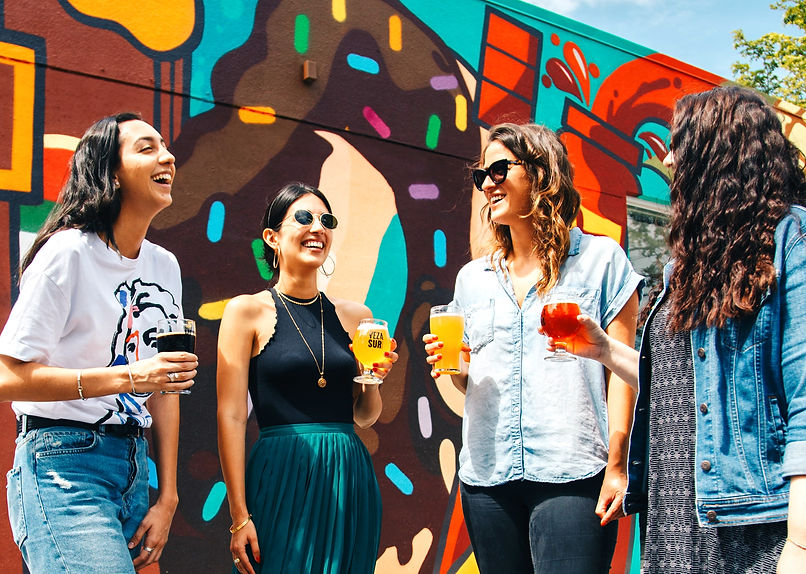 four women holding drinks while laughing together during daytime_edited.jpg