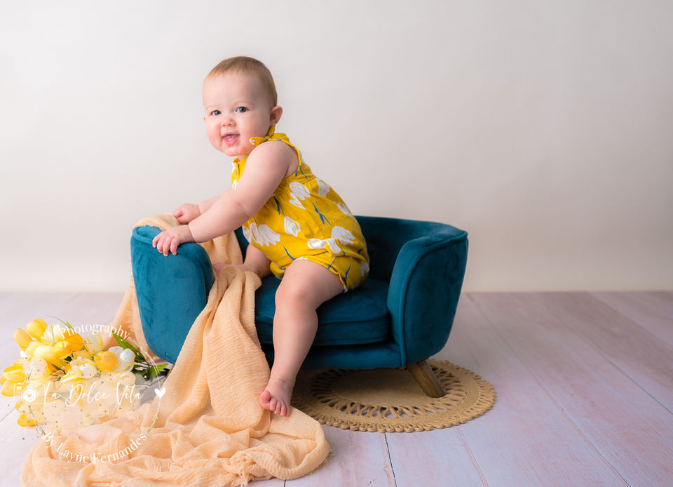 baby sitting on small couch