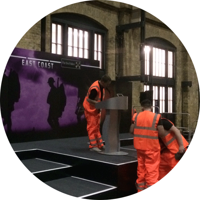 exhibition builders creating a stand in a train station