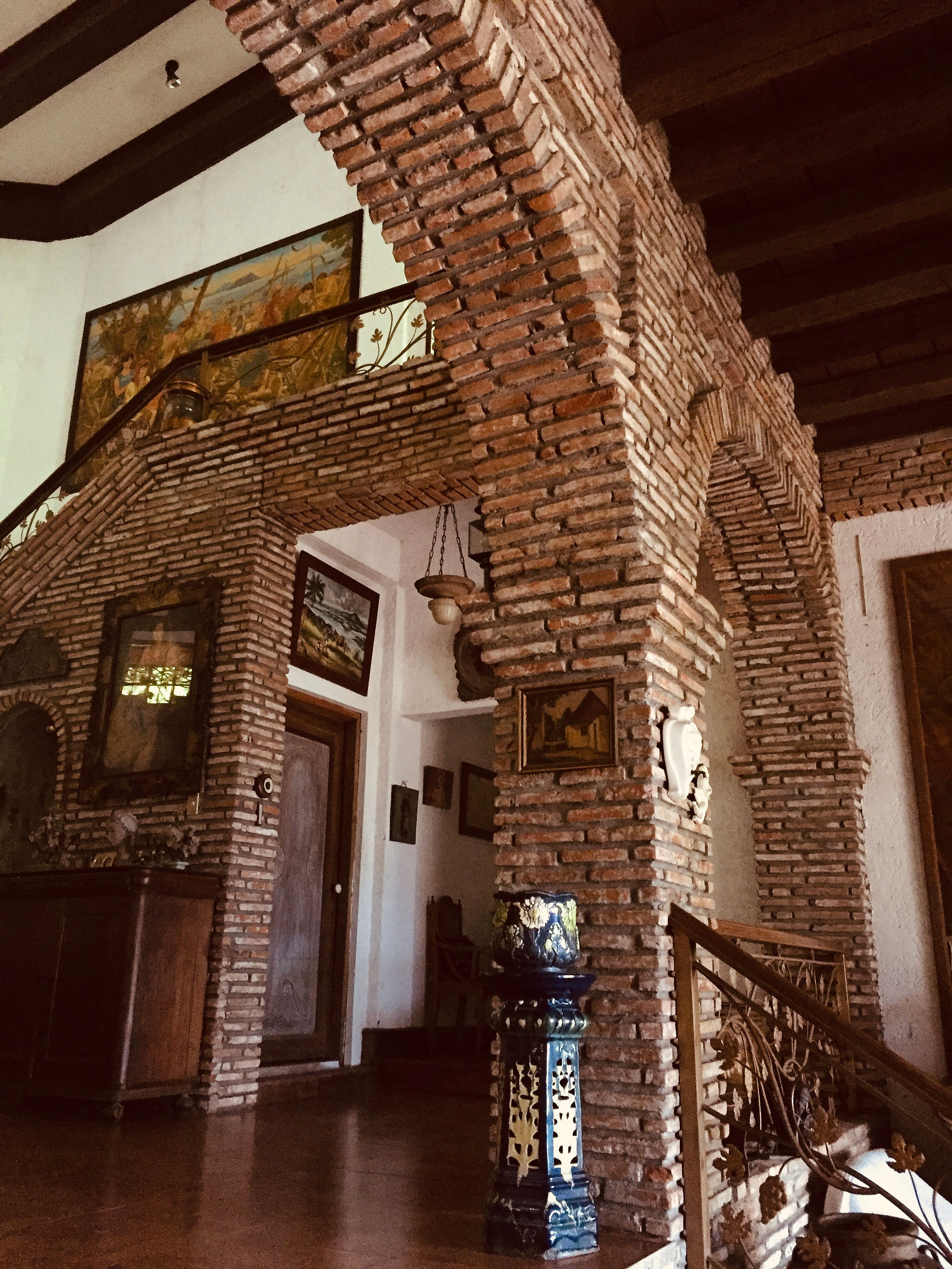 Brick arches of our vacation home with antiques on the walls