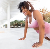 side-view-smiley-woman-training-with-headphones.jpg
