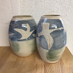 Elegant wheelthrown stoneware vase, depicting wild geese in flight. Faded blue and green tones complement this design.
