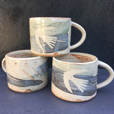 Stoneware espresso cups, decorated with blue and green slip and a bird motif