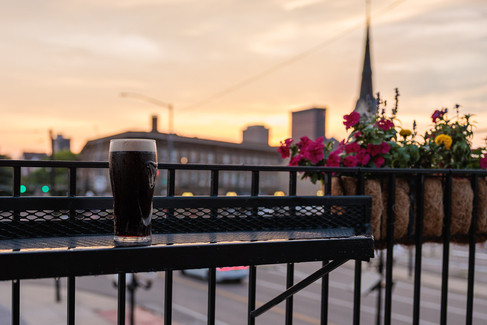 Guinness pint on the patio railing at Dublin Pub Dayton Ohio at sunset