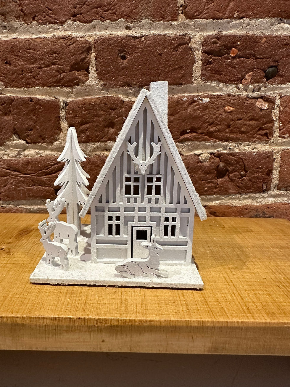 White wooden house with reindeer