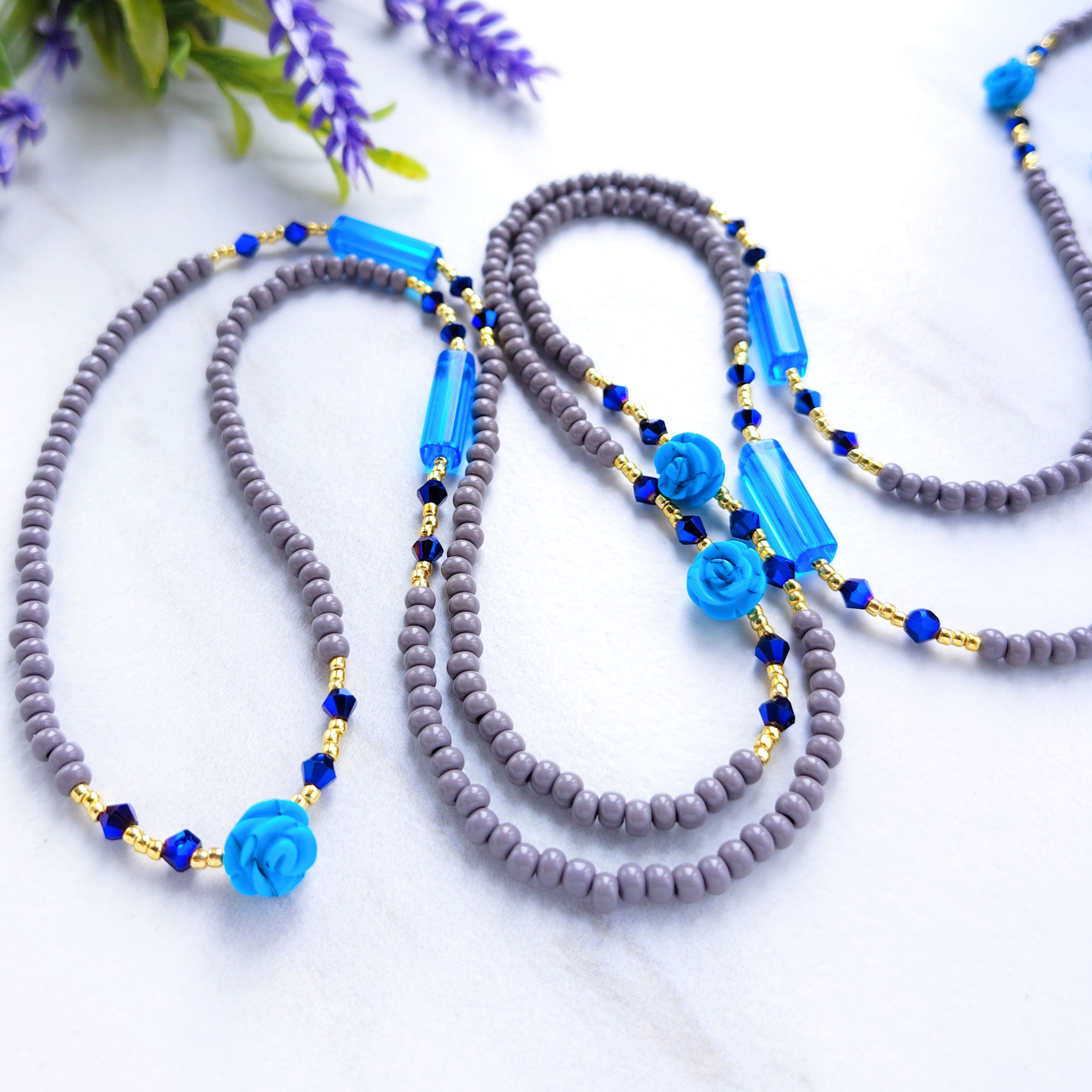 Turquoise carved rose waist beads with grey seed beads, blue glass tubes, and electric blue crystal accents