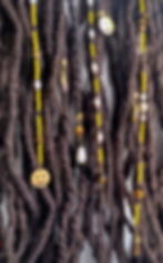 Thumbnail: Yellow long loc beads with tiger's eye, pearl beads, bronze crystal accents, and brass smiley charms.