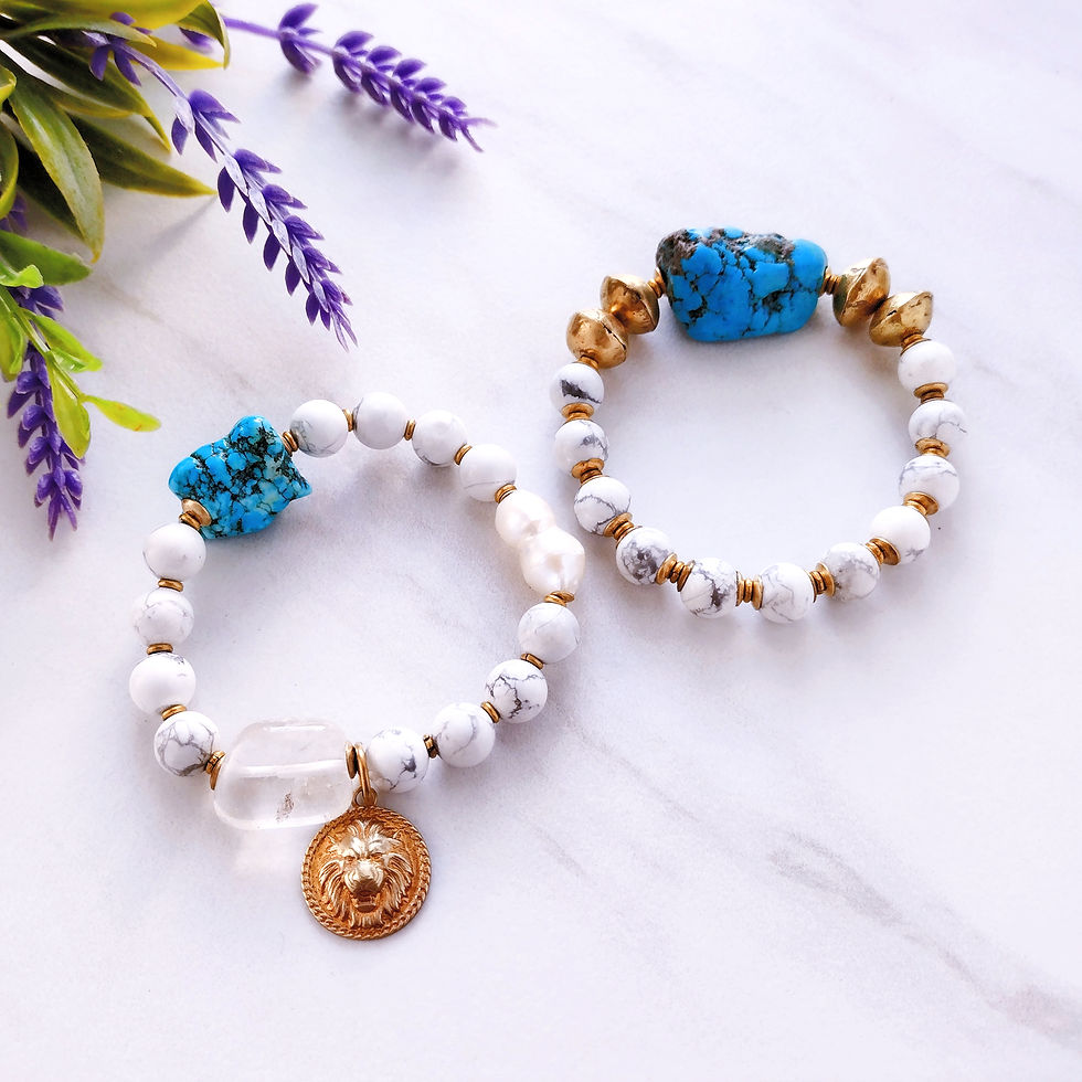 Thumbnail: Lion’s Light bracelet set in white howlite with turquoise howlite, pearl, quartz beads, and brass lion charm
