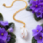 Thumbnail: Raw crystal quartz pendant hand-wrapped in brass wire on a 24-inch brass chain.