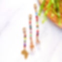 Africa Loc Bead set features multicolored African glass, cowrie shells, a brass Africa charm, and quartz for a vibrant, cultural look.
