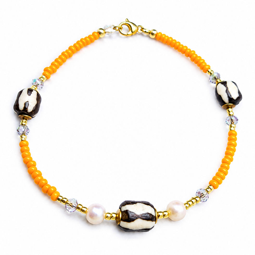 Elegant African-inspired pearl anklet in orange with batik bead and crystal details