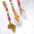 Thumbnail: Close-up of African glass loc beads with cowrie shell and quartz on 9mm adjustable cuffs for locs