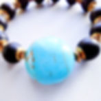 Thumbnail: Handmade stretch bracelet with Ankh charm, turquoise focal bead, and onyx beads