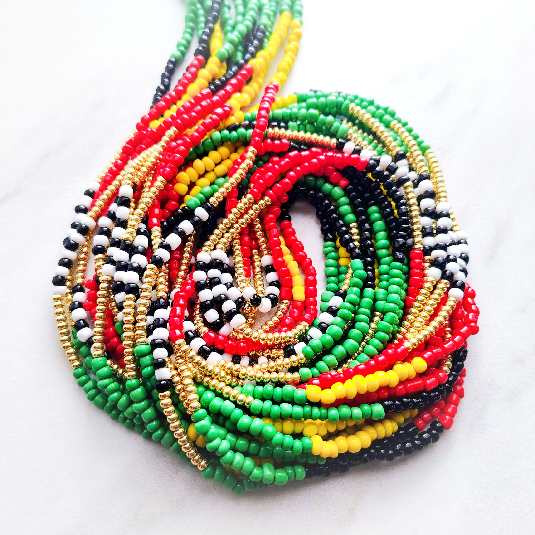 Island Sunrise waist beads with yellow green red black white and gold beads