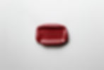 A red wax seal with the word STRIPPED embossed on it lies on a white surface. The seal is centrally placed and has a glossy finish.