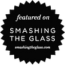 This is a black seal or badge with jagged edges. It says "featured on SMASHING THE GLASS" and displays the website smashingth