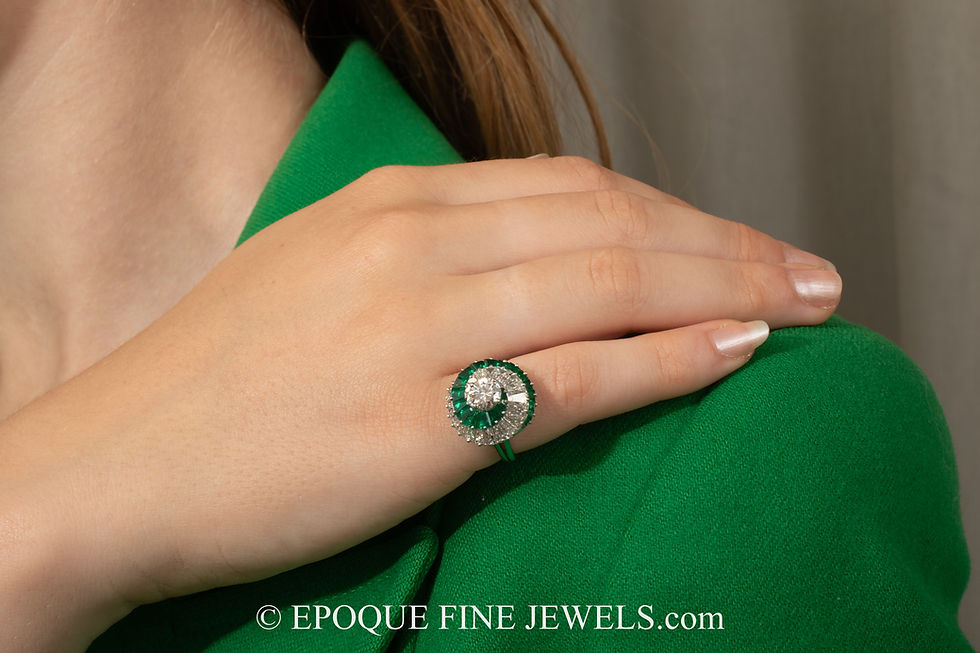 Thumbnail: An unusual emerald and diamond swirl ring by Cartier