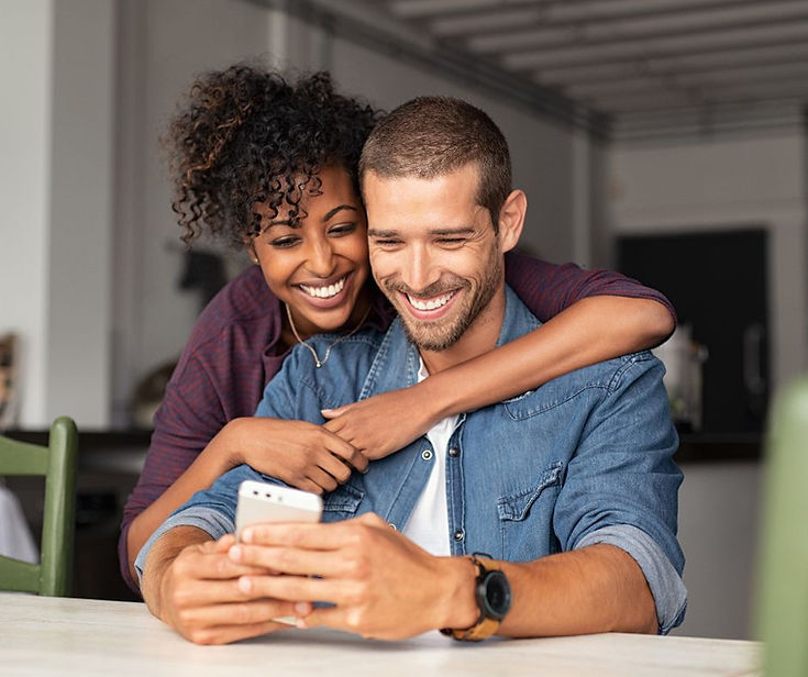 smiling couple looking at phone