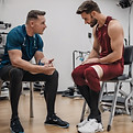 An athlete telling a physical therapist a story.jpg