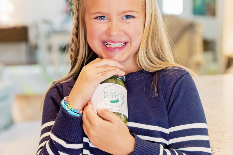 Louise Read holding a jar of Sweetfully Pickled Bread & Butter Pickles
