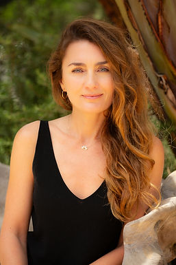 Dr. Colette Sinclair outside against a leafy green background