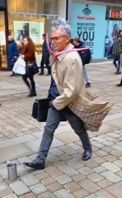 Windswept man - Standing still in Market street, Manchester, Uk