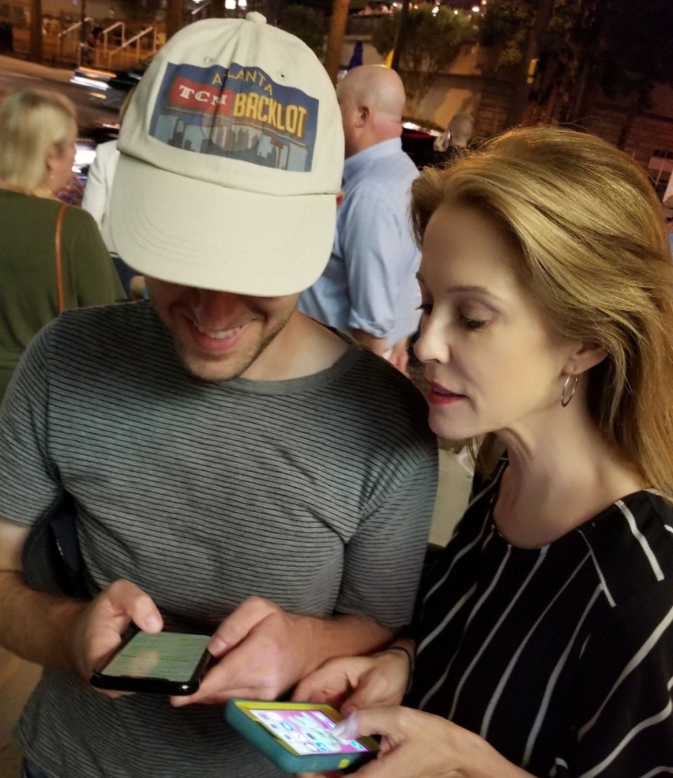 "Keep looking at your phone, it's a great shot of the hat!" Totally natural, not at all staged.