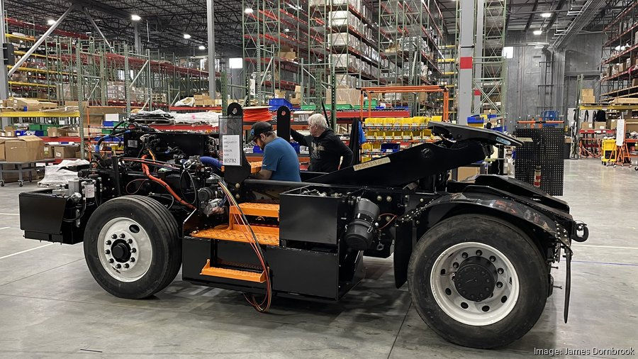 Workers assemble an electric yard truck at Orange EV's new 400,000-square-foot production plant in Kansas City, Kansas.