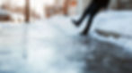 Person slipping on ice on a New Hampshire sidewalk, illustrating a slip and fall injury.