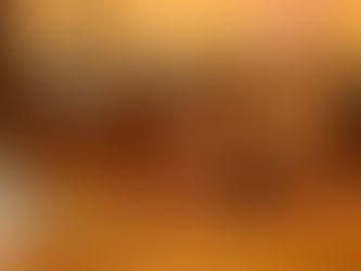 The scales of justice are positioned on a table. The background is blurred out.