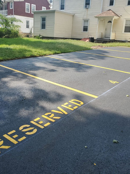 Line striping with stencils for a small four-unit house