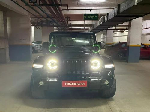 Wrangler side fenders on black Thar with glowing headlights.