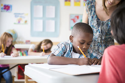Child receiving one-on-one behavioral support in a classroom setting.