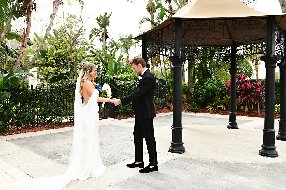The groom takes a moment to see his future wife in her wedding dress.