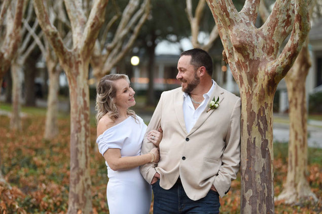 Bride and groom in a group of trees during the Florida winter