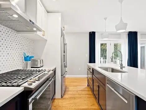Sun-filled kitchen with large doors leading to the patio area.