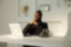 Owner, Michelle, seated, with hands intersected at a table