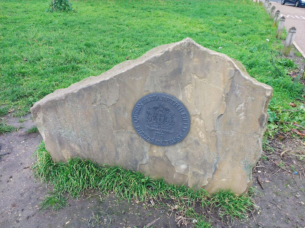 The commemorative plaque recognising that Figges Marsh is protected as a Fields in Trust Queen Elizabeth II Field in celebration of HM Queen Elizabeth II's Diamond Jubilee & the 2012 London Olympics. Photo credit https://commons.wikimedia.org/wiki/File:Recent_name_plate_erected_at_southern_end_of_Figges_Marsh,_image_1_of_2.jpg