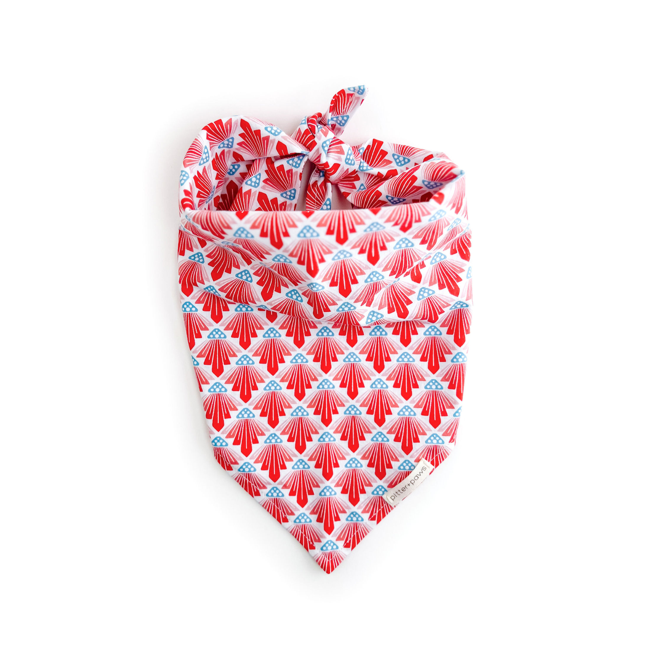 tie-on dog bandana in art deco print in reds, white, and blue. handmade by pitter+paws with Cotton & Steel fabric
