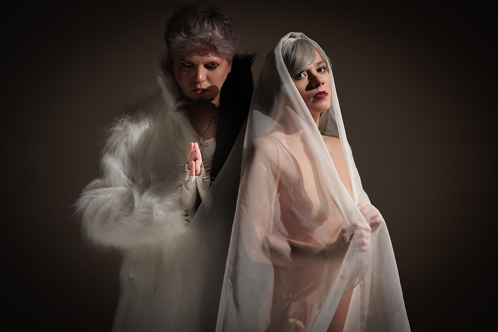 A woman and a man standing in white clothes in a mystical atmosphere.