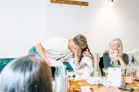 Bride and groom kissing at their wedding breakfast