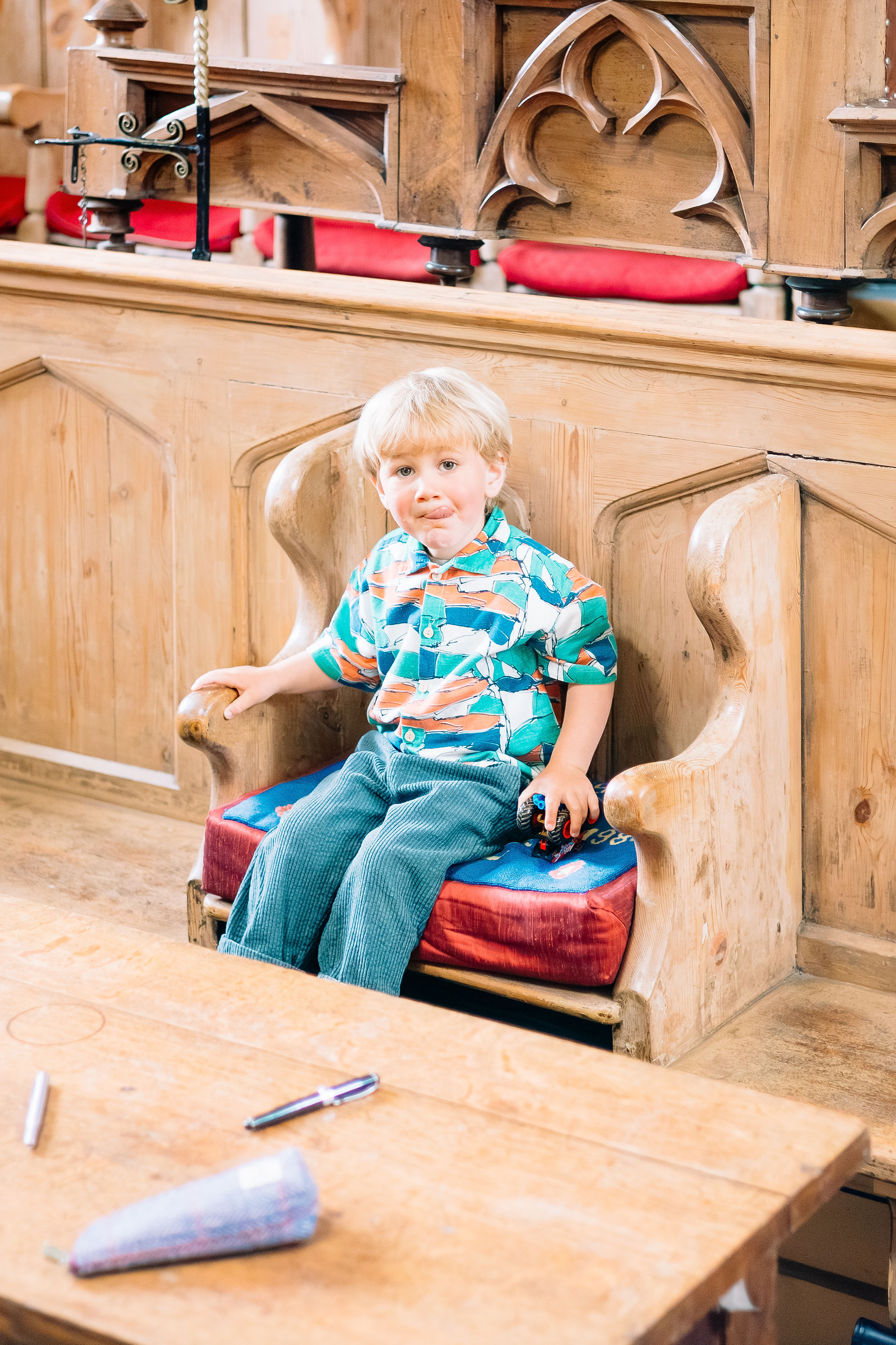 Young blonde boy sat in a tudor council building