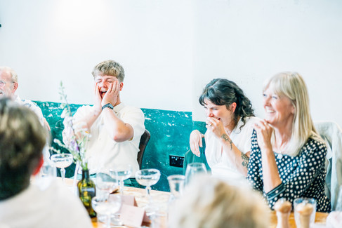 Wedding guests looking surprised and laughing