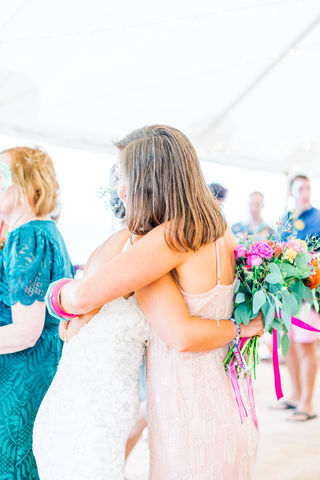 Bride and friend embracing in a hug