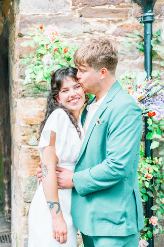 Bride and groom stood in front of tudor building