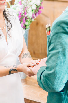 close up of bride and groom holding hands at their wedding ceremony