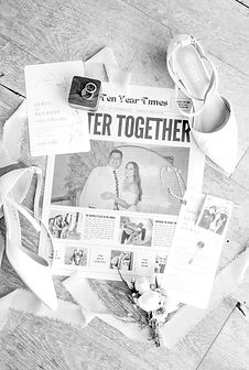 wedding flay lay with newspaper, shoes, jewellery and menu card