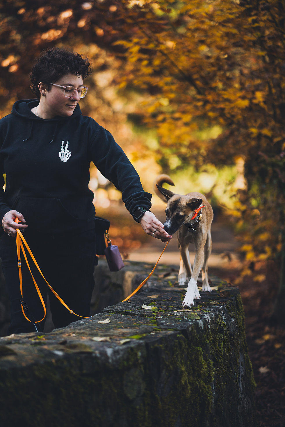 Tamara giving a treat to a dog on a leash