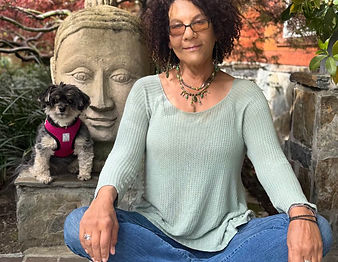 Bev, professional pet sitter with cute black and tan dog named Namaste in a garden in The East Bay, 