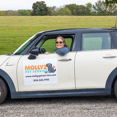 Professional pet sitter driving a small white car for Mollyz Pet Service in Richmond, VA